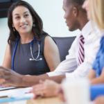 doctor talking to coworkers during meeting