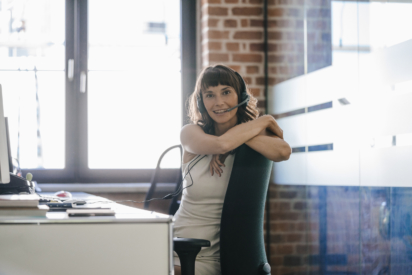 women sitting at her desk with headset on