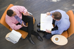 Overhead view of two men in chairs meeting