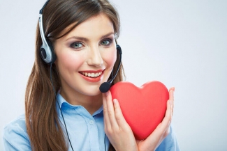 women holding a heart shaped item close to her face