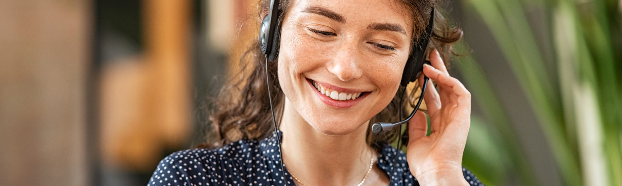 young women talking on the phone with headphones on