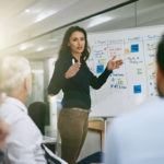 women presenting workflow to colleagues
