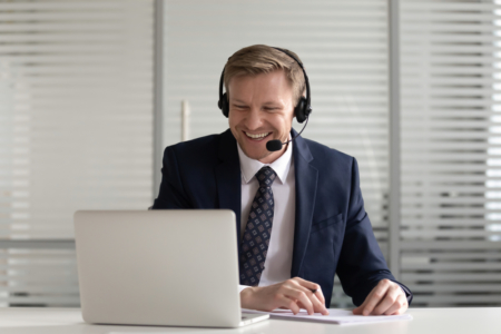 business man smiling on a call with headphones on
