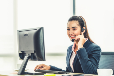 Women at desktop talking through headset