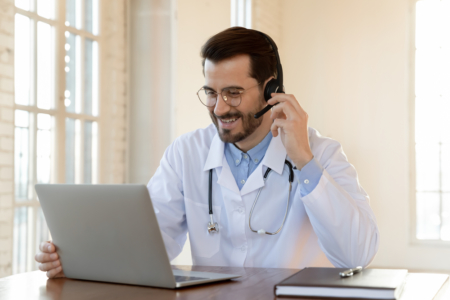 doctor on his laptop with headset on