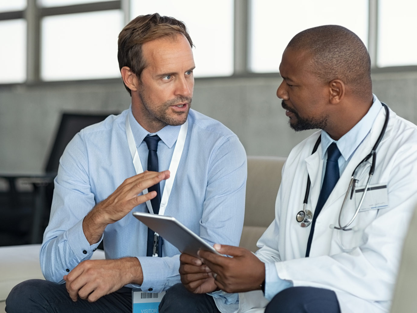 Doctor in conversation with pharmaceutical representative