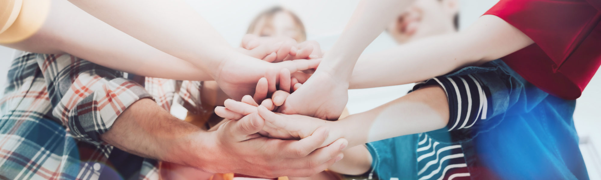 Co-working startup business team and teamwork concept. Young team putting hands up in creative office. Happy and cheerful people giving strength motivation