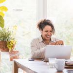 Woman smiling at her computer while in agriculture sales training session
