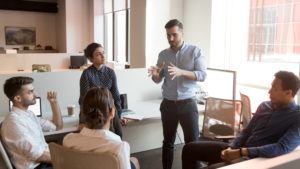 man coaching his coworkers in meeting