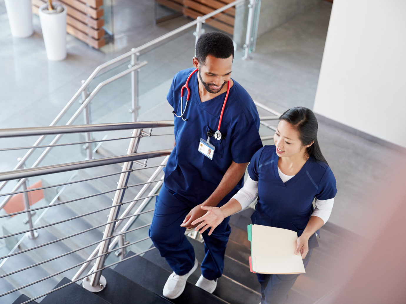 two nurses walking up staircase
