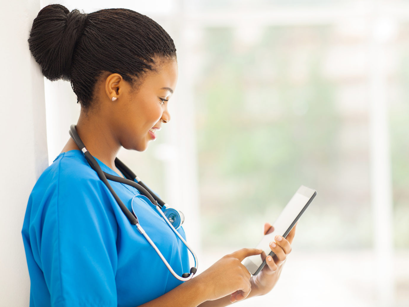 young black nurse with tablet