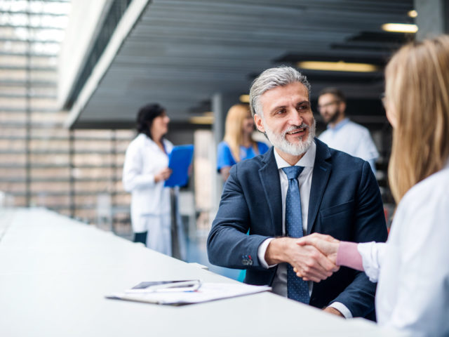 man shaking hand with customer