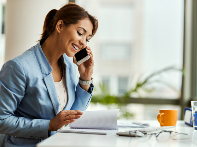 women on cell phone smiling