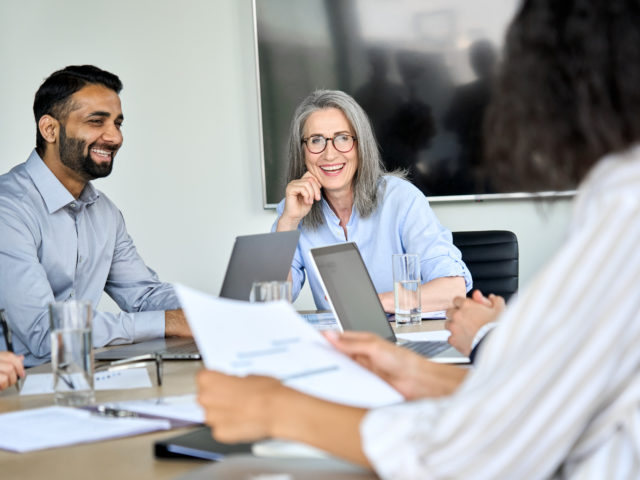 coworkers smiling during meeting