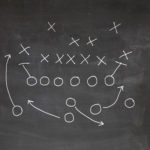 football play strategy on chalk board