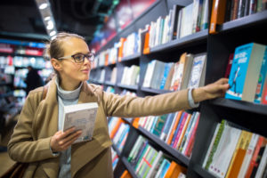 women picking out book