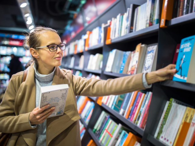 women picking out book