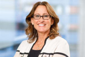 Professional headshot of Julie-ann Wessinger smiling against a neutral background.