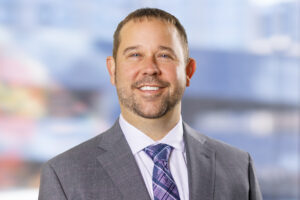 Professional headshot of Jeremy Armbrister smiling, captured in a bright indoor setting.