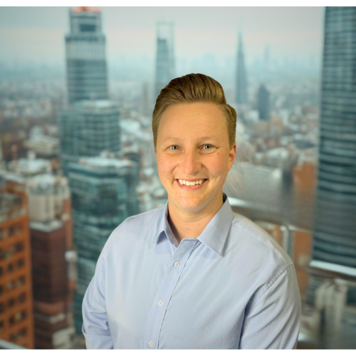 Professional headshot of E. Holldorf smiling in a corporate setting.