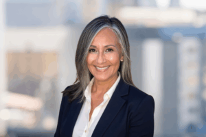Professional headshot of Cynthia Escartin smiling, captured in a clean and modern corporate style.